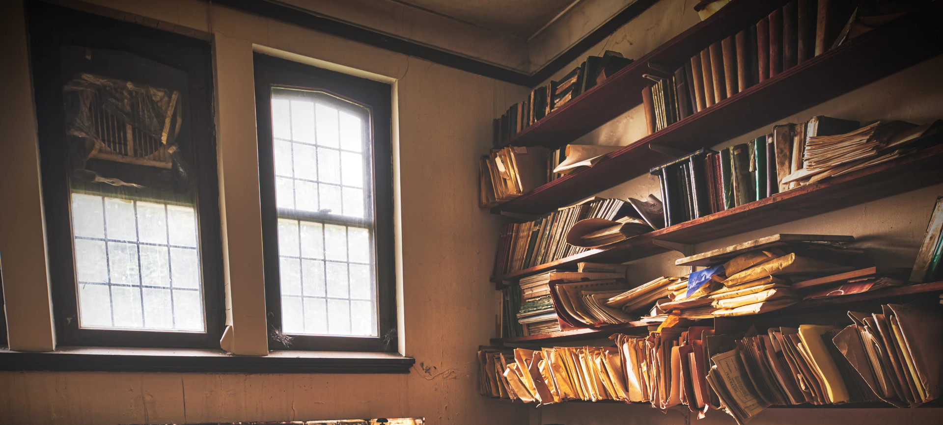 display of messy folder and books on shelves